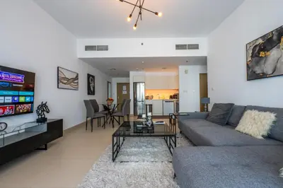 a living room with a couch and a table at Luxuswohnung in Creek Harbour in Dubai