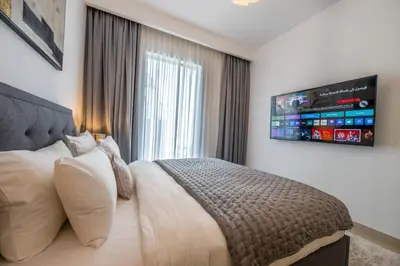 a bedroom with a bed with a tv on the wall at Luxuswohnung in Creek Harbour in Dubai
