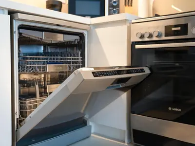 an open dishwasher in a kitchen with at Luxuswohnung in Creek Harbour in Dubai