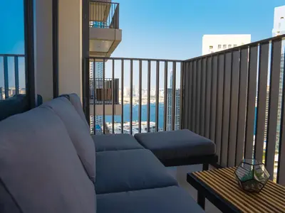 a balcony with a couch and a view of the ocean at Luxuswohnung in Creek Harbour in Dubai