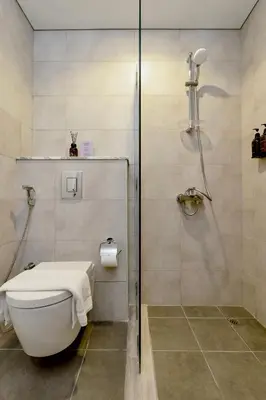 a bathroom with a toilet and a shower at New Cozy 1BR in the Heart of the City in Dubai