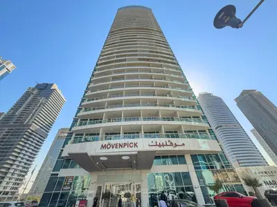 a tall building with a sign on the side of it at Large 1 BR Duplex With Lake View in Dubai