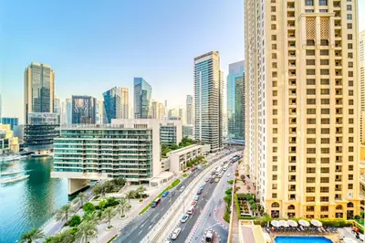 a city skyline with tall buildings and a river at Elite 1 BR in JBR with Marina Views in Dubai