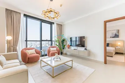 a living room with a couch and a table at Spacious 3BR Apartment with Assistant Room & Stunning Creek Views in The Dubai Creek Residences South Tower 1, Creek Harbour by Deluxe Holiday Homes in Dubai