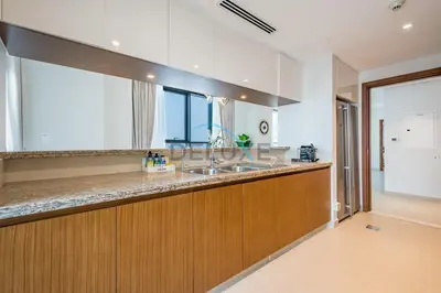 a kitchen with a sink and a counter top at Spacious 3BR Apartment with Assistant Room & Stunning Creek Views in The Dubai Creek Residences South Tower 1, Creek Harbour by Deluxe Holiday Homes in Dubai