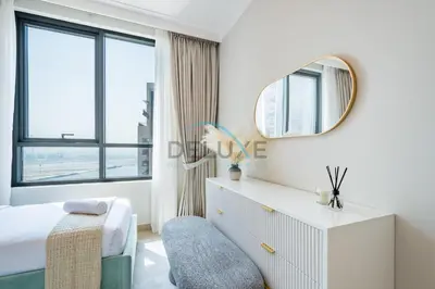 a white bedroom with a bed and a mirror at Spacious 3BR Apartment with Assistant Room & Stunning Creek Views in The Dubai Creek Residences South Tower 1, Creek Harbour by Deluxe Holiday Homes in Dubai
