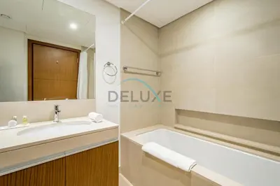 a bathroom with a tub and a sink at Spacious 3BR Apartment with Assistant Room & Stunning Creek Views in The Dubai Creek Residences South Tower 1, Creek Harbour by Deluxe Holiday Homes in Dubai