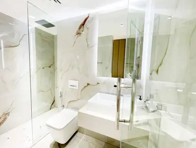 a white bathroom with a toilet and a sink at Luxury 4 Bed Apartment in Sadaf 8 on The Walk JBR in Dubai