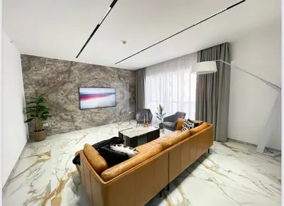 a living room with a couch and a tv at Luxury 4 Bed Apartment in Sadaf 8 on The Walk JBR in Dubai