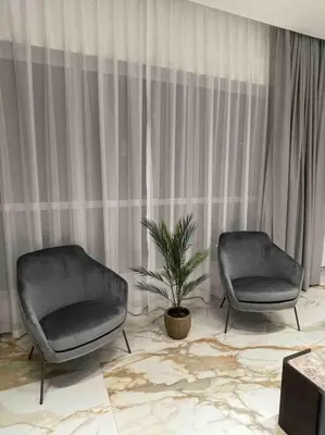 two chairs and a potted plant in a room at Luxury 4 Bed Apartment in Sadaf 8 on The Walk JBR in Dubai