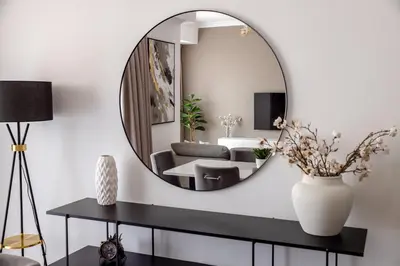 a living room with a mirror on the wall at Beautiful and bright 1 bedroom apartment! Sofia ! in Dubai
