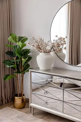 a dressing table with a mirror and a plant at Beautiful and bright 1 bedroom apartment! Sofia ! in Dubai