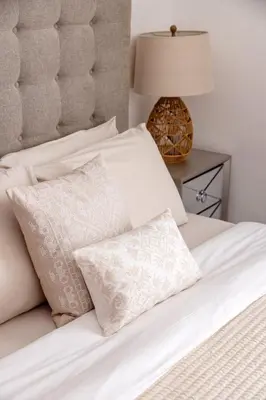 a white bed with white pillows and a lamp at Beautiful and bright 1 bedroom apartment! Sofia ! in Dubai
