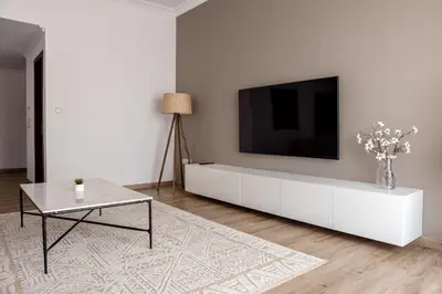 a living room with a white cabinet with a tv on it at Beautiful and bright 1 bedroom apartment! Sofia ! in Dubai