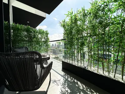 a balcony with a bench and plants on a building at Indulge in a Regal Retreat at JVC in Dubai