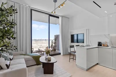 a living room with a couch and a table at Elegant Living in 1 BDR at JVC with Top Amenities in Dubai