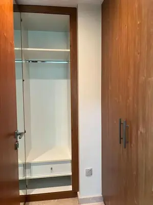 an empty glass closet with a wooden door at Apartment in Business Bay, Dubai UAE in Dubai