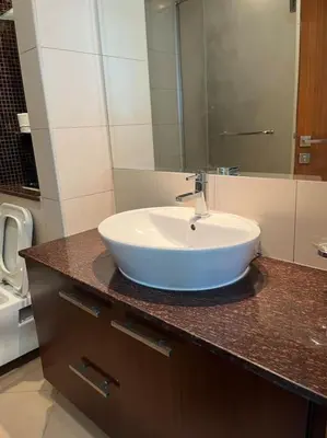 a bathroom with a white sink on a counter at Apartment in Business Bay, Dubai UAE in Dubai