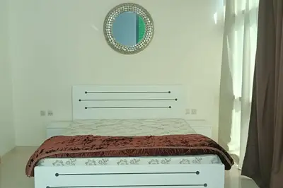 a bedroom with a bed with a mirror on the wall at Apartment in Business Bay, Dubai UAE in Dubai