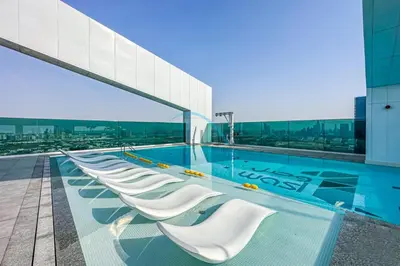 a swimming pool on the roof of a building at Contemporary 1BR in Al Kifaf Residences West, Bur Dubai by Deluxe Holiday Homes in Dubai