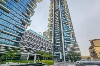 a tall building with cars parked in front of it at Contemporary 1BR in Al Kifaf Residences West, Bur Dubai by Deluxe Holiday Homes in Dubai