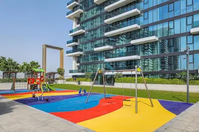 a playground in front of a tall building at Contemporary 1BR in Al Kifaf Residences West, Bur Dubai by Deluxe Holiday Homes in Dubai