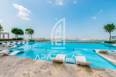 a view of a swimming pool with white lounge chairs at Beach Vista - Private Beach & Palm Jumeirah Views in Dubai