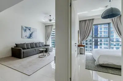 a bedroom with a bed and a couch at Beach Vista - Private Beach & Palm Jumeirah Views in Dubai