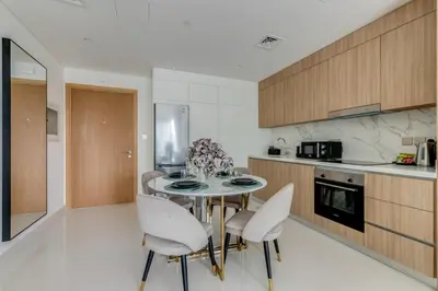 a kitchen with a table and chairs in a room at Beach Vista - Private Beach & Palm Jumeirah Views in Dubai