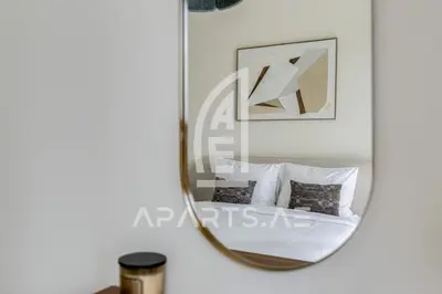 a mirror in a room with a bed at Beach Vista - Private Beach & Palm Jumeirah Views in Dubai