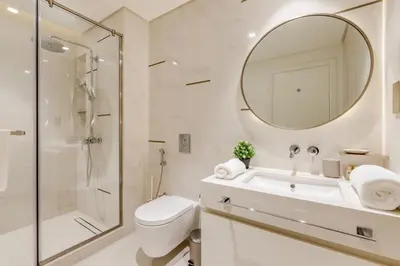 a bathroom with a toilet sink and a mirror at Beach Vista - Private Beach & Palm Jumeirah Views in Dubai