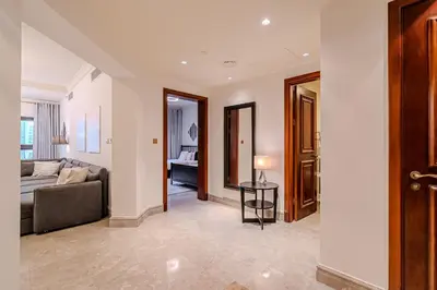 a living room with a couch and a table at Stylish 2 bedroom apartment with Maid Room I Fairmont South Residence I Palm Jumeirah in Dubai