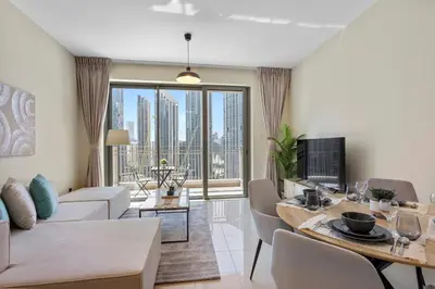 a living room with a table and a living room with a couch at Upscale 1 bedroom in the heart of Downtown in Dubai