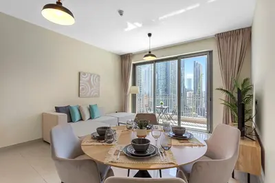 a dining room with a table and chairs and a large window at Upscale 1 bedroom in the heart of Downtown in Dubai