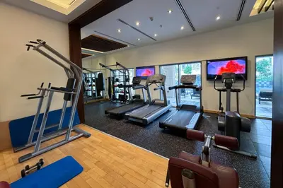 a gym with several tread machines in a room at Upscale 1 bedroom in the heart of Downtown in Dubai
