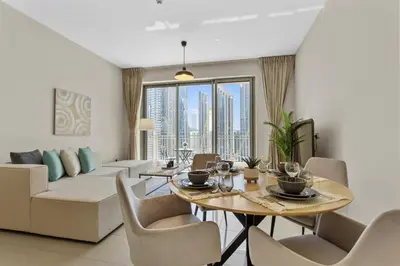 a living room with a table and a couch at Upscale 1 bedroom in the heart of Downtown in Dubai