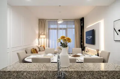 a kitchen and living room with a table and chairs at Bellevue Towers by Luxe Living - Full Burj Khalifa View in Dubai