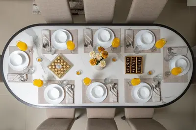 an overhead view of a dining table with white plates at Bellevue Towers by Luxe Living - Full Burj Khalifa View in Dubai