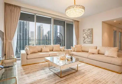 a living room with a couch and a glass table at NewArabian Forte Downtown in Dubai