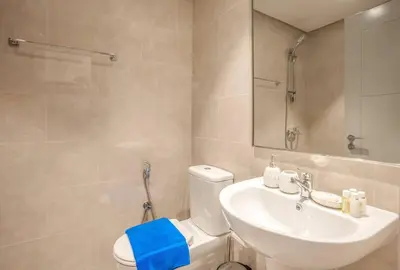 a bathroom with a white toilet and a sink at NewArabian Forte Downtown in Dubai