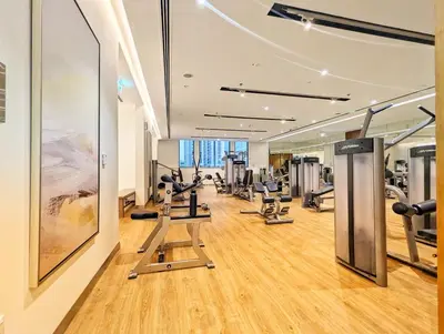a gym with treadmills and exercise equipment in a building at LUXE | Elegant 2BR | Harbour View | Stylish & Cozy in Dubai