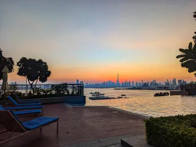 a view of a city skyline at sunset at LUXE | Elegant 2BR | Harbour View | Stylish & Cozy in Dubai