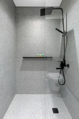 a bathroom with a glass shower with a toilet at Modern Meydan Studio Apartment - 15 min Drive to Downtown Dubai Mall in Dubai