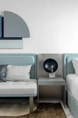 a room with a couch and a table with a lamp at Modern Meydan Studio Apartment - 15 min Drive to Downtown Dubai Mall in Dubai
