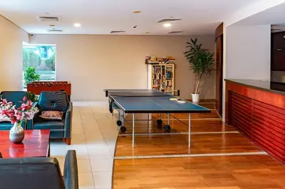 a living room with a ping pong table in it at Prime Retreats - steps to Grosvenor Hotel Marina in Dubai