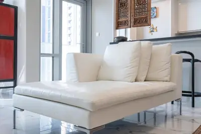 a white couch sitting in a living room at StayShort - Cozy 1-Bedroom Haven in Business Bay in Dubai