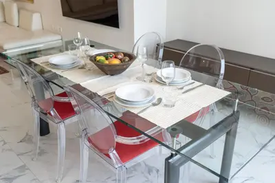 a glass table with a bowl of fruit on top of it at StayShort - Cozy 1-Bedroom Haven in Business Bay in Dubai