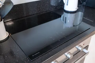 a close up of a black stove top oven at StayShort - Cozy 1-Bedroom Haven in Business Bay in Dubai