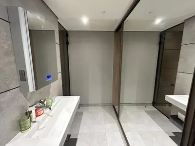 a bathroom with a tub and two sinks and a mirror at Premium 1BHK Apt In Signature living, JVC! Pool view in Dubai