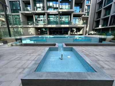 a swimming pool in a building with a clock in it at Premium 1BHK Apt In Signature living, JVC! Pool view in Dubai